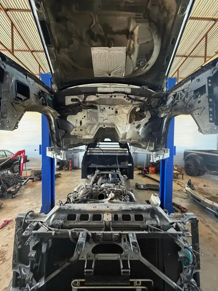 A truck with the cab removed on a two-post lift at Young Motorsports