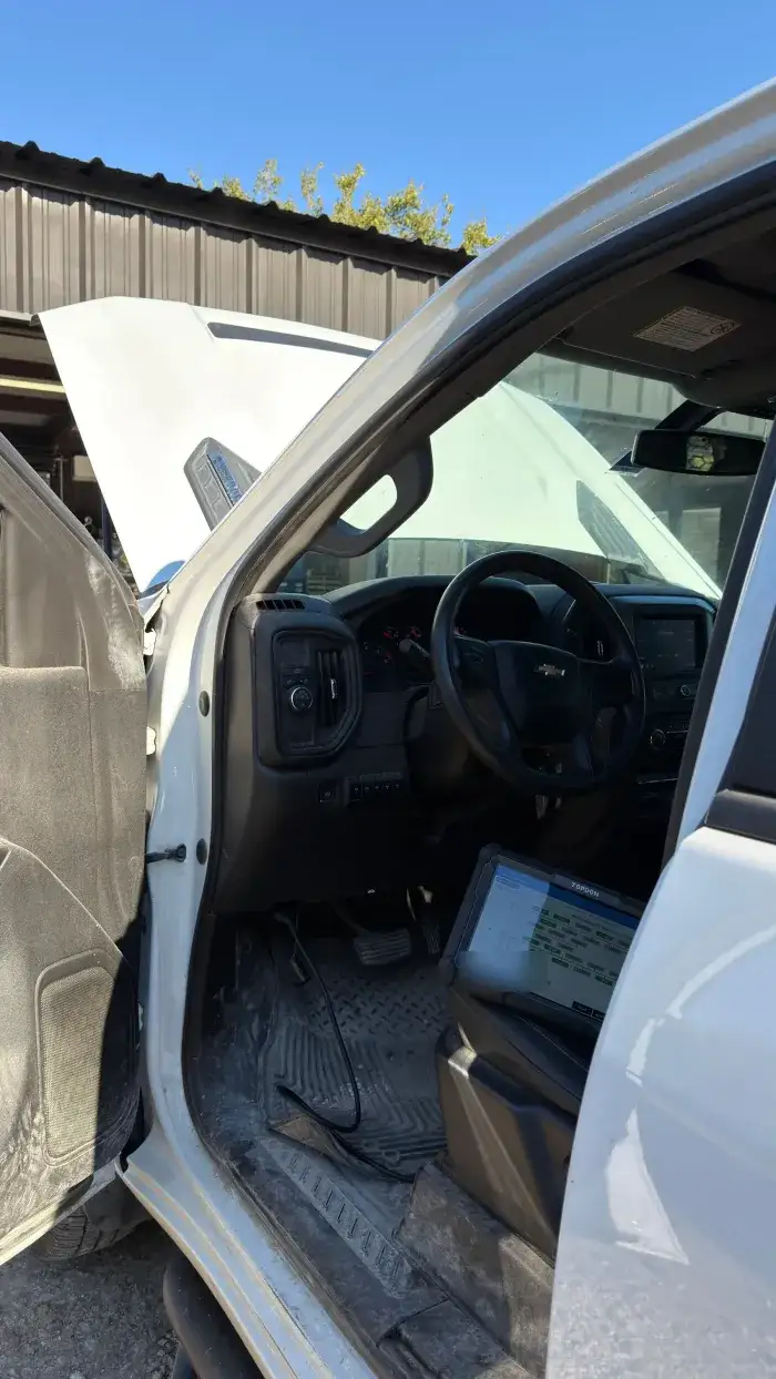 A scan tool on the seat of a Duramax truck during diagnostics at Young Motorsports